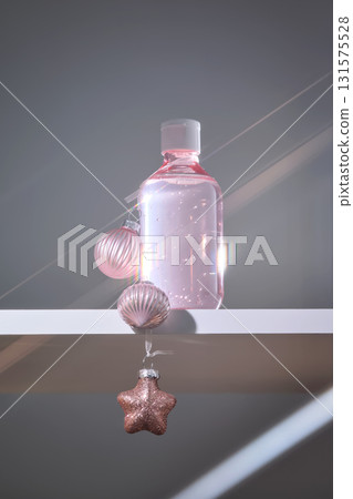 A large bottle of serum or tonic with Christmas toys. The Christmas concept. 131575528