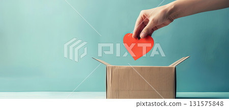 hand putting paper heart into donation box charity kindness giving support 131575848