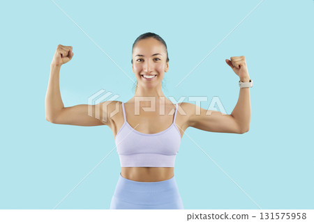 Sporty fit strong beautiful woman in sportswear working out indoors in sportswear, making power  131575958