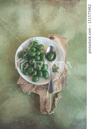 Chalkidiki olives, classic Greek green olive, on a plate, with a spoon, top view, no people, 131575962