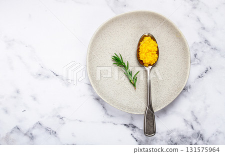 Yuzu caviar is pearly, on a spoon, top view, light background, no people. Yuzu caviar is pearly, on a spoon, top view, light background, no people. 131575964