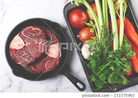 knuckle on the bone, raw meat for ossobuco, in a cast-iron pan, baking sheet with vegetables, top view, no people, knuckle on the bone, raw meat for ossobuco, in a cast-iron pan, baking sheet with vegetables, top view, no people, 131575965