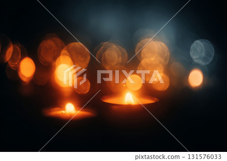 Burning candles with soft orange flames and blurred bokeh lights 131576033