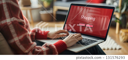 Woman shopping online with laptop at home 131576293
