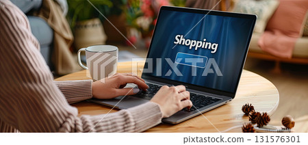 Woman shopping online with laptop at home Woman shopping online with laptop at home 131576301