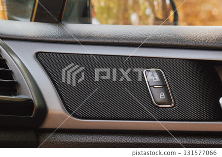Door lock buttons on car interior panel. Door lock buttons on car interior panel. 131577066