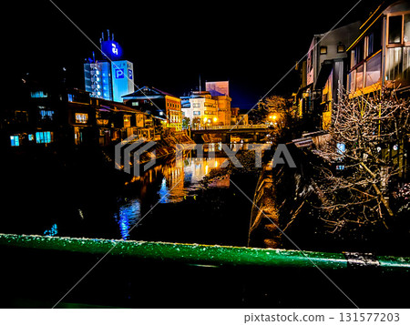 A view of Takayama City, with lights reflected on the water under a winter night sky A view of Takayama City, with lights reflected on the water under a winter night sky 131577203