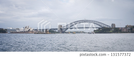 Wide panorama of Sydney opera house and harbor bridge as seen from the sea, Sydney, Australia Wide panorama of Sydney opera house and harbor bridge as seen from the sea, Sydney, Australia 131577372