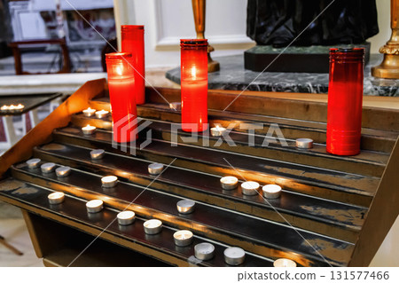 Candlelit catholic church interior with glowing light Candlelit catholic church interior with glowing light 131577466