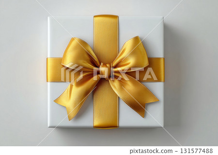 Elegant present. Top view. Elegant square box wrapped with a silver bow on white background. Jewelry, birthdays and luxury branding. 131577488