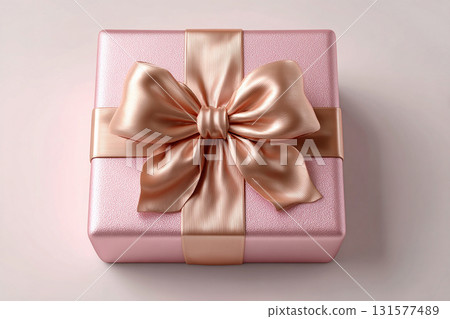 Luxury packaging. Top view. Square pink box wrapped with a silver bow on white background. Jewelry, birthdays and luxury branding. Elegant packaging. 131577489