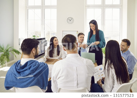 Office Team Conducting Group Meeting Or Training Session 131577523