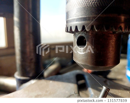 Close View of Drilling Machine Chuck During Metalworking Process in Workshop Setting Close View of Drilling Machine Chuck During Metalworking Process in Workshop Setting 131577839