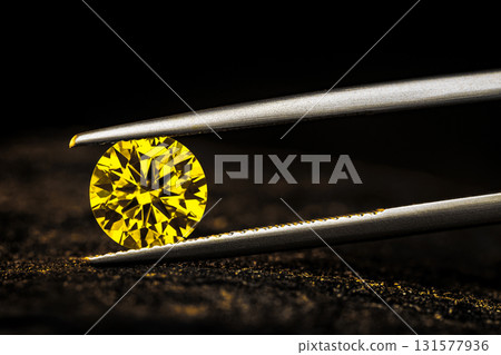 A yellow diamond is displayed in a magnified view A yellow diamond is displayed in a magnified view 131577936