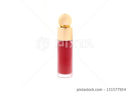 A small bottle of red lipstick is sitting on a white background 131577954