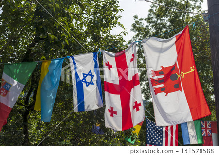 Shot of the different flags in the rope. Georgian, Israeli, Ukrainian flags in the middle. USA flag behind Shot of the different flags in the rope. Georgian, Israeli, Ukrainian flags in the middle. USA flag behind 131578588