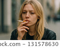 Young blonde woman smoking cigarette 131578630