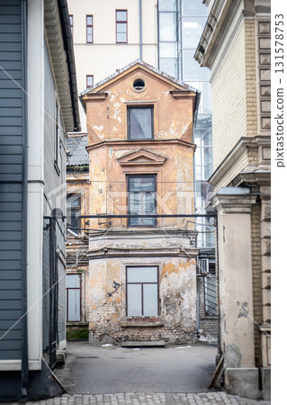Dilapidated Old Building Between Modern Architecture in City Alley Dilapidated Old Building Between Modern Architecture in City Alley 131578753