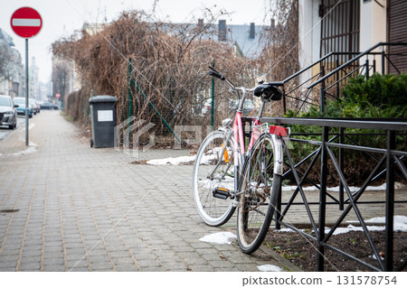 Parked Pink Bicycle on Sidewalk with No Entry Sign and Trash Bin Nearby Parked Pink Bicycle on Sidewalk with No Entry Sign and Trash Bin Nearby 131578754