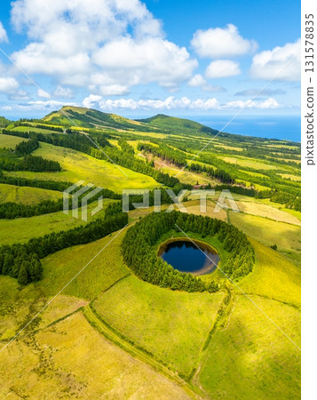 Pond Pau Pique and Lush Green Hills. Atlantic Ocean, Azores, Sao Miguel Island. Portugal. Aerial Pond Pau Pique and Lush Green Hills. Atlantic Ocean, Azores, Sao Miguel Island. Portugal. Aerial 131578835