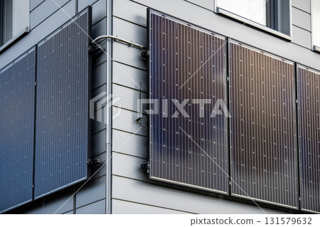 Modern Building Exterior With Solar Panels Mounted On Grey Siding Wall: Sustainable Energy Technology, Clean Power Source, Photovoltaic Cells, Environmental Friendly Design Under Natural Daylight Modern Building Exterior With Solar Panels Mounted On Grey Siding Wall: Sustainable Energy Technology, Clean Power Source, Photovoltaic Cells, Environmental Friendly Design Under Natural Daylight 131579632