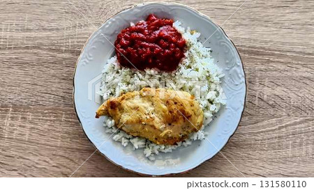 A visually appealing plate of rice, chicken, and flavorful sauces A visually appealing plate of rice, chicken, and flavorful sauces 131580110