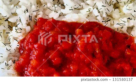Enjoy a captivating video of rice in rich tomato sauce, a comfort food 131580137