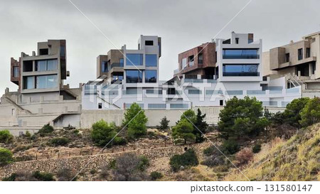 This video shows modern houses on a picturesque hillside, blending beauty This video shows modern houses on a picturesque hillside, blending beauty 131580147