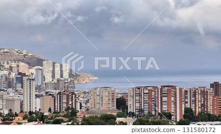 Aerial journey over a cityscape, blending urban and natural beauty 131580172