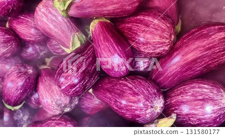 Vibrant purple eggplants arranged beautifully emphasize freshness 131580177