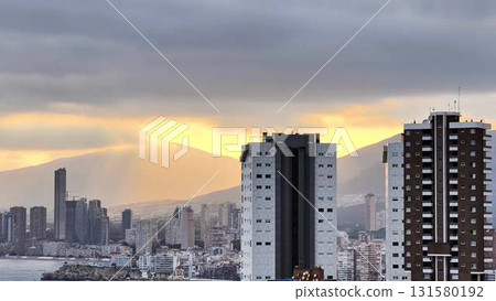 A stunning city skyline at sunset, highlighting urban and nature 131580192