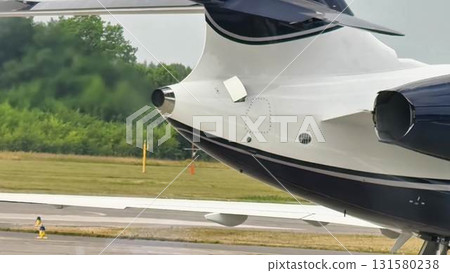 A closeup of the airplanes tail, engine, and wing, highlighting their intricate design 131580238