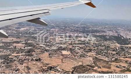A stunning aerial view seen from an airplane window showcasing a sprawling city landscape 131580245