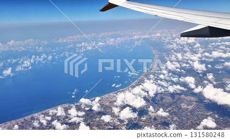 An aerial view from a plane reveals the serene ocean and stunning coastal landscape An aerial view from a plane reveals the serene ocean and stunning coastal landscape 131580248