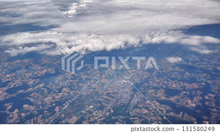 A breathtaking aerial view showcasing diverse landscapes beneath dramatic cloudy skies 131580249