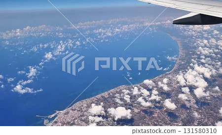 An Aerial View of a Beautiful Coastal Landscape Captured from an Airplane Window 131580310
