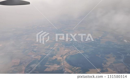 Stunning Aerial Views of a Beautiful Landscape Featuring Clouds and Airplane Wing 131580314