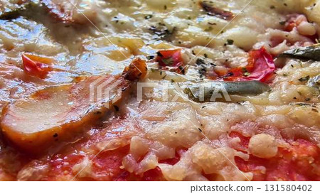 A Mouthwatering Closeup View of Savory Pizza with Tasty and Colorful Toppings On It 131580402