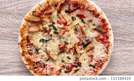 Enjoy a mouthwatering Chicken Pizza topped with fresh Red Bell Peppers and melted Cheese 131580420