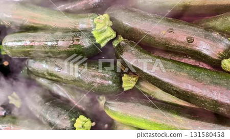 Fresh Zucchini Steamed with Water Droplets for a Healthy and Colorful Appetizer Dish Fresh Zucchini Steamed with Water Droplets for a Healthy and Colorful Appetizer Dish 131580458