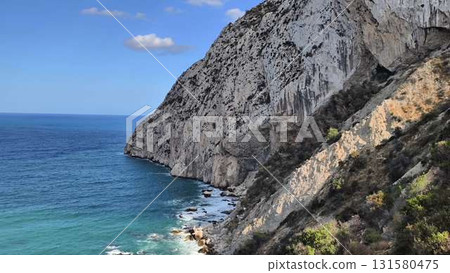 Stunning Coastal Cliffs Majestically Overlooking the Clear, Sparkling, and Blue Sea Stunning Coastal Cliffs Majestically Overlooking the Clear, Sparkling, and Blue Sea 131580475