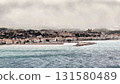 Enjoy a breathtaking view of a serene seaside town with a picturesque pier and stunning scenery 131580489
