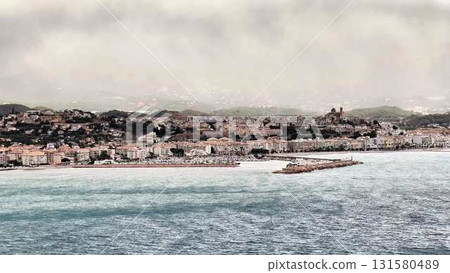 Enjoy a breathtaking view of a serene seaside town with a picturesque pier and stunning scenery Enjoy a breathtaking view of a serene seaside town with a picturesque pier and stunning scenery 131580489