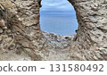 A breathtaking scenic coastal view seen through a stunning archway in a rugged rocky landscape, 131580492