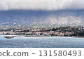 Coastal City Beautifully Set Against Dramatic Skies Full of Color and Movement Above 131580493