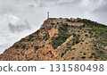 A breathtaking scenic hilltop features a communication tower overlooking the landscape below 131580498
