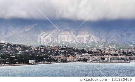 Experience the Stunning Coastal View Accompanied by a Dramatic Mountain Backdrop and Inspiration 131580499