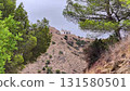 Experience breathtaking views of a hilltop building surrounded by lush greenery, inviting adventure 131580501