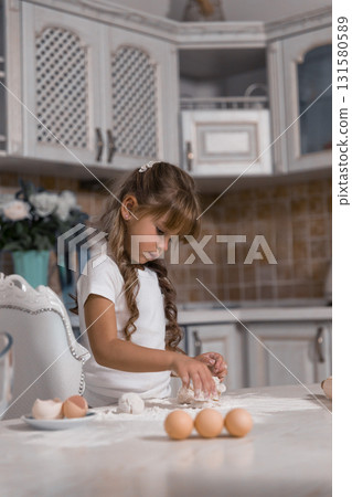 young girl carefully kneads dough while surrounded by eggs and flour. She is focused on creating a delicious cake showcasing her love for baking. young girl carefully kneads dough while surrounded by eggs and flour. She is focused on creating a delicious cake showcasing her love for baking. 131580589