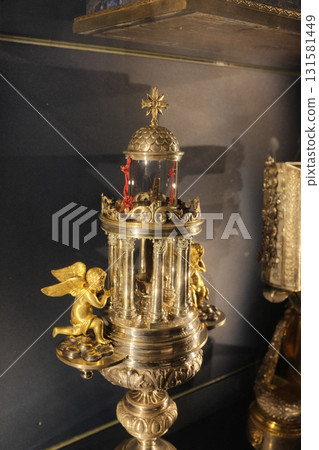 Treasury reliquaries at Basilica of the Holy Cross in Jerusalem Rome gold monstrance cross and sacred vessels in glass display case museum interior editorial use only. High quality photo 131581449